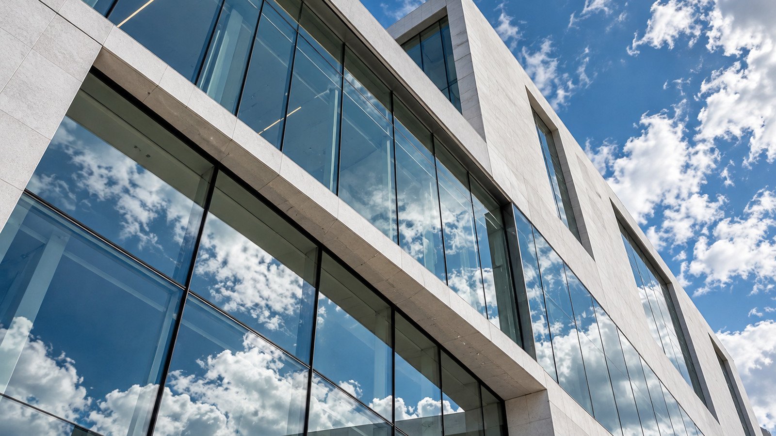 Glass facade of a modern building against blue sky